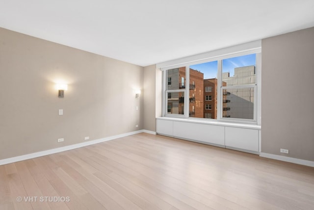 spare room with light hardwood / wood-style flooring