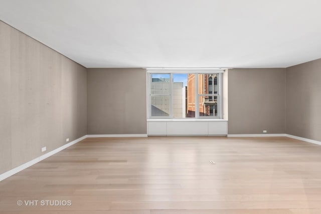 spare room featuring light hardwood / wood-style floors