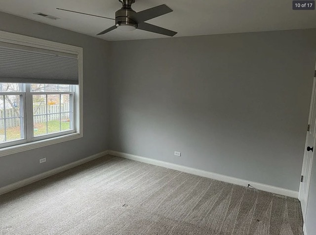 unfurnished room with ceiling fan and carpet floors