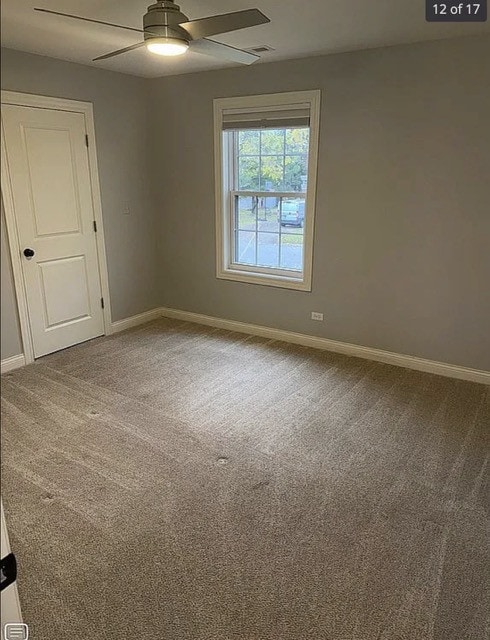 unfurnished room with carpet and ceiling fan