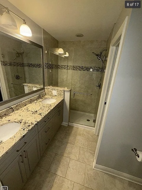 bathroom with vanity and a shower with door