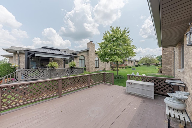 wooden deck featuring a gazebo and a yard