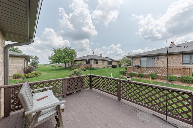 wooden terrace with a yard