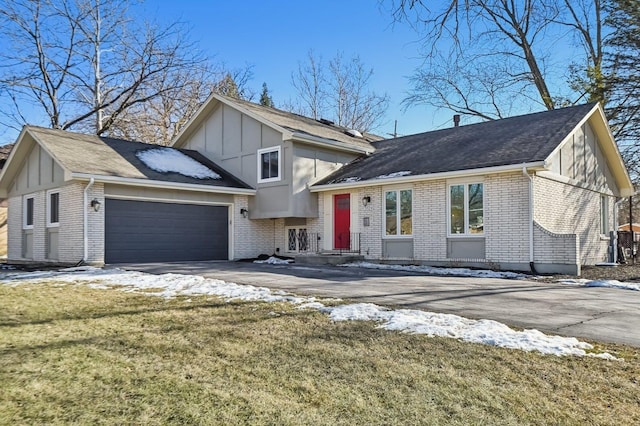 split level home featuring a garage and a front lawn