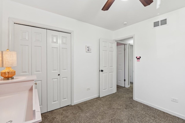 unfurnished bedroom featuring ceiling fan, carpet floors, and a closet