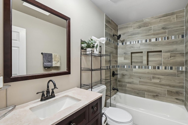 full bathroom featuring tiled shower / bath combo, vanity, a skylight, and toilet