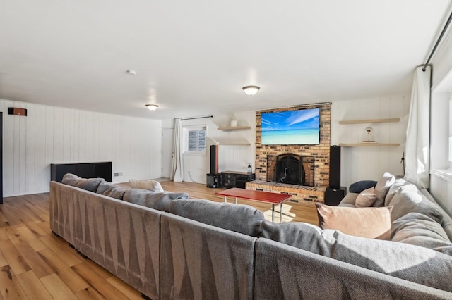 living room featuring a fireplace and light hardwood / wood-style flooring