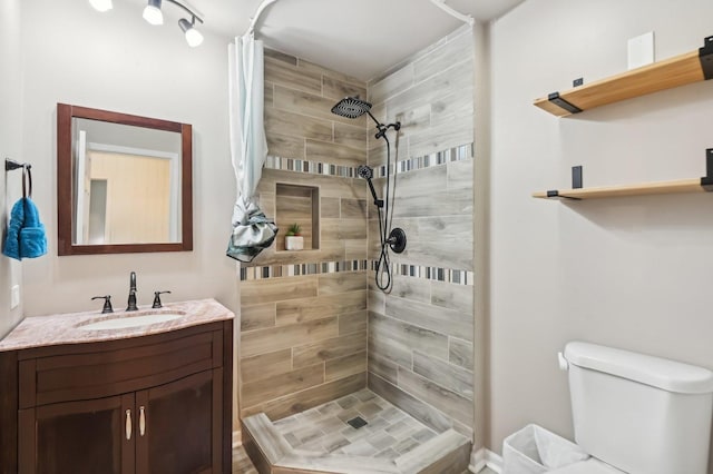 bathroom featuring vanity, curtained shower, and toilet