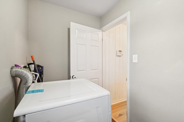 clothes washing area featuring washer / clothes dryer and wood-type flooring