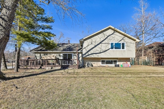 back of house with a wooden deck and a lawn