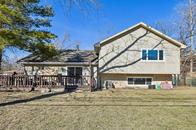 back of property featuring a yard and a deck