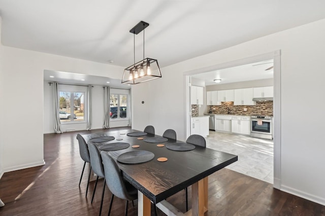 dining area featuring dark wood-type flooring