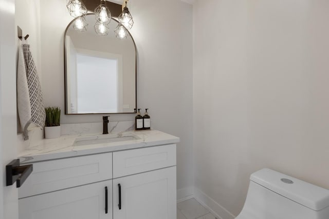 bathroom featuring toilet, vanity, and tile patterned floors