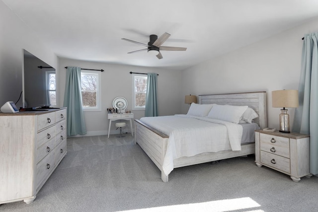 bedroom with ceiling fan and light carpet