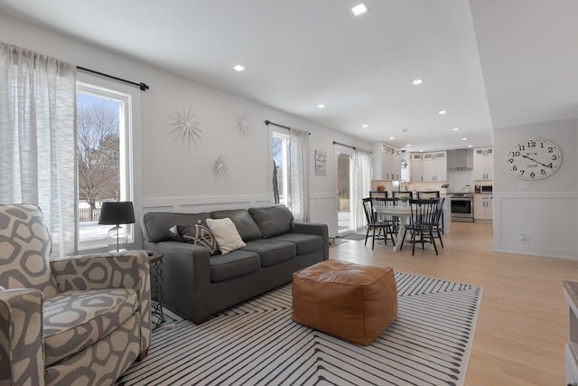 living room featuring light hardwood / wood-style flooring and plenty of natural light