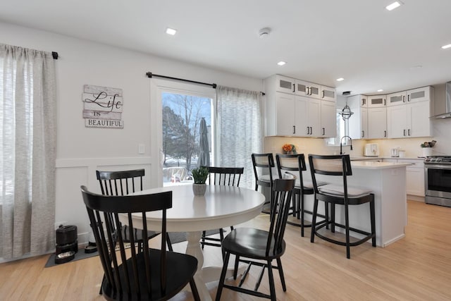 dining room featuring sink and light hardwood / wood-style flooring