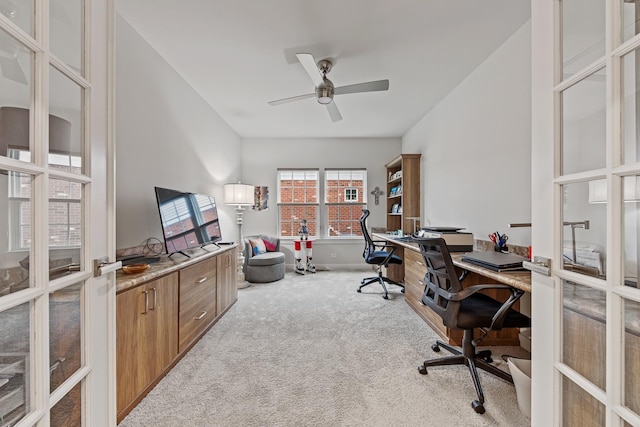 home office featuring ceiling fan, light colored carpet, and french doors