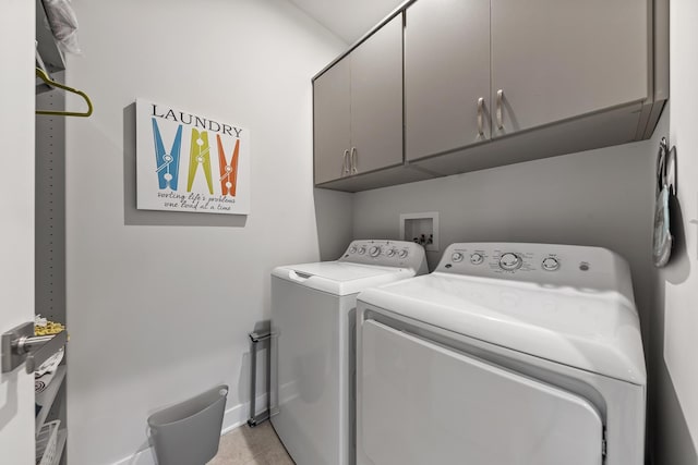 washroom featuring washer and dryer and cabinets