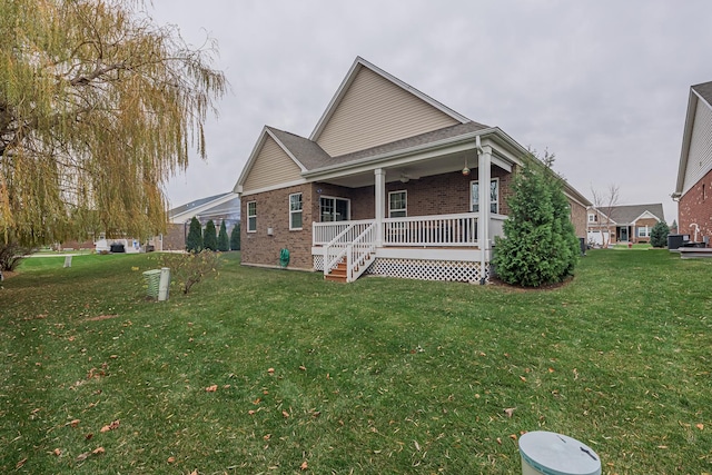 view of front of home with covered porch and a front yard