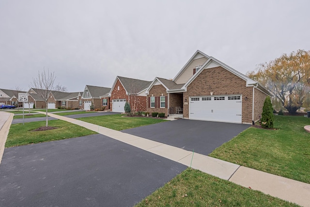 view of front of home with a front yard and a garage