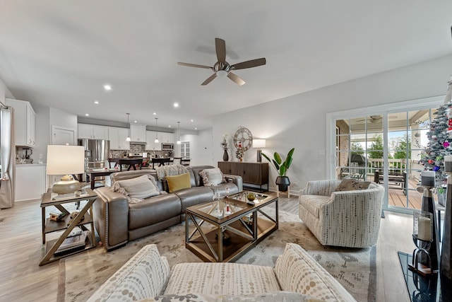 living room with ceiling fan and light wood-type flooring