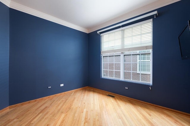 spare room featuring crown molding and wood-type flooring