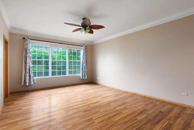 empty room with ceiling fan, light wood-type flooring, and ornamental molding