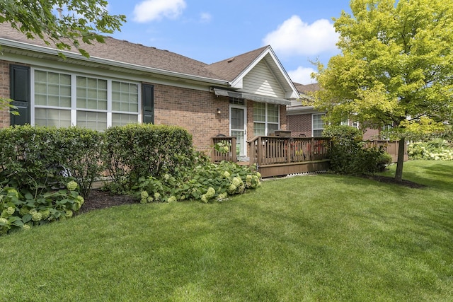 view of home's exterior featuring a yard and a wooden deck