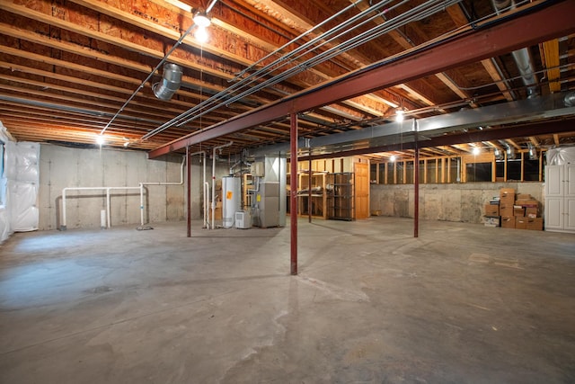 basement featuring heating unit and water heater