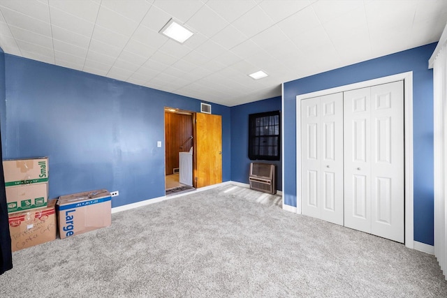 unfurnished bedroom with a closet and carpet