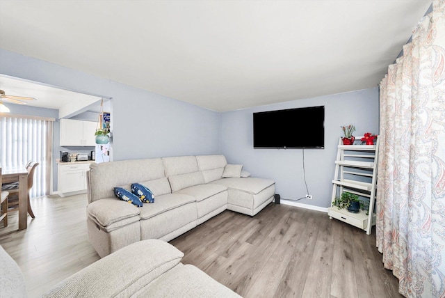 living room with ceiling fan and light hardwood / wood-style floors