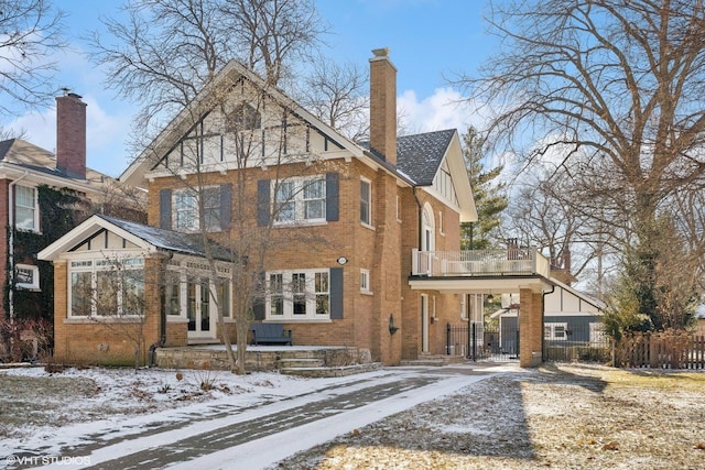 snow covered house featuring a balcony