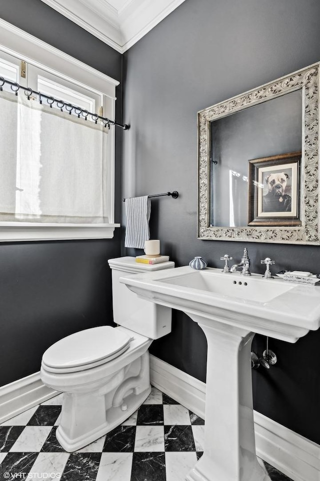 bathroom with crown molding and toilet