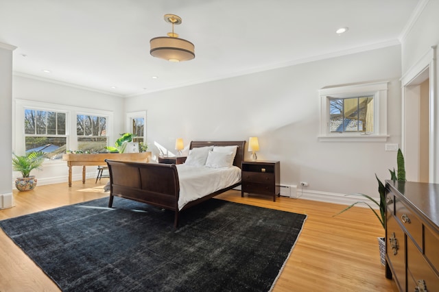 bedroom featuring a baseboard heating unit, ornamental molding, and light hardwood / wood-style flooring