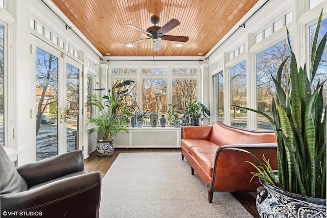 sunroom / solarium featuring wooden ceiling, ceiling fan, and a wealth of natural light