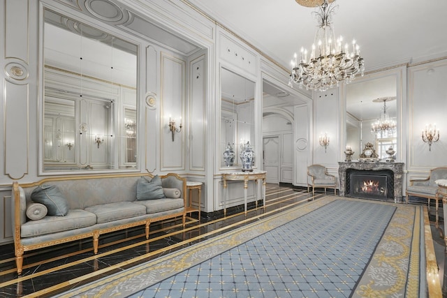 bathroom featuring a fireplace, an inviting chandelier, and crown molding