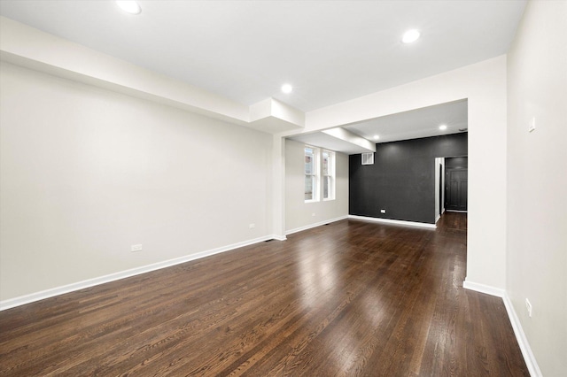 unfurnished living room with dark wood-type flooring