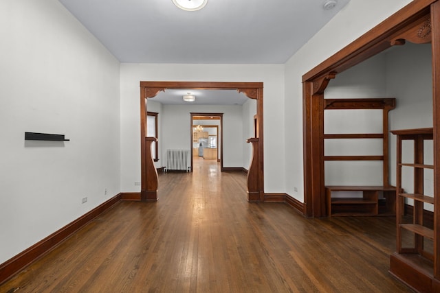 hallway featuring radiator and dark wood-type flooring