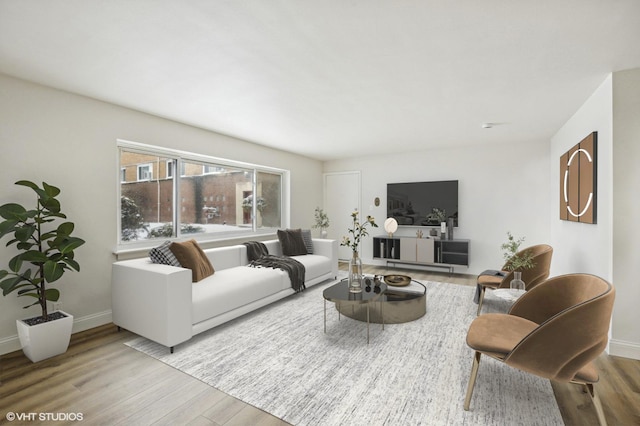 living area with baseboards and wood finished floors