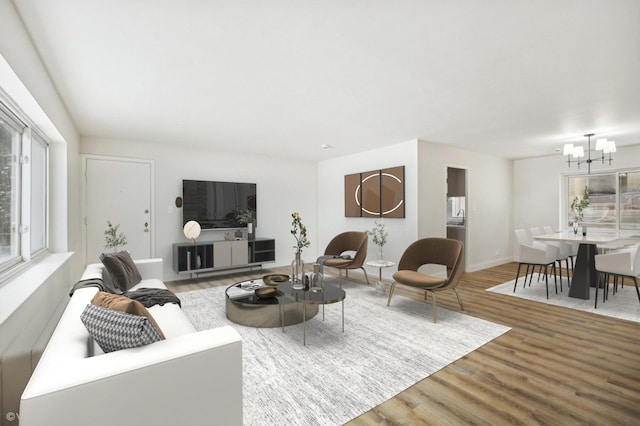 living area with wood finished floors and a chandelier