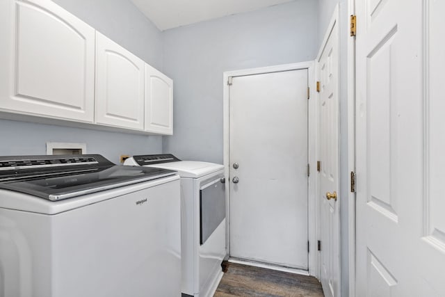 clothes washing area featuring cabinets, separate washer and dryer, and dark wood-type flooring