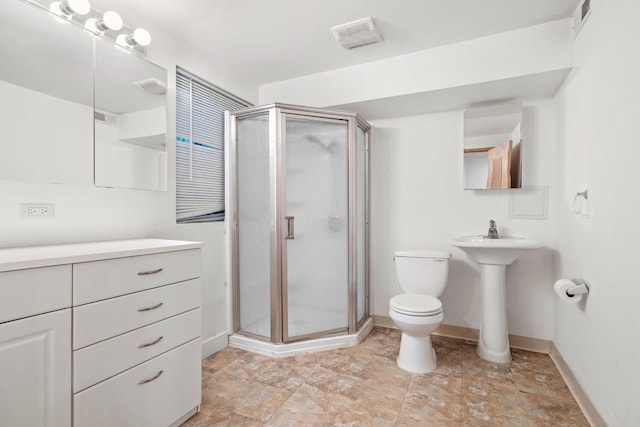 bathroom featuring toilet and a shower with shower door