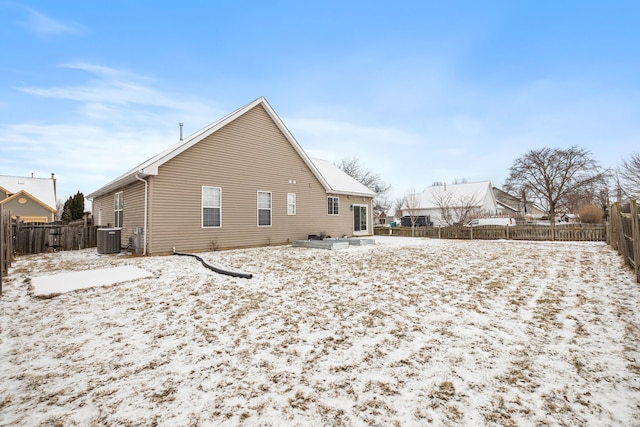 snow covered property featuring central AC