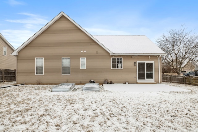 view of snow covered rear of property