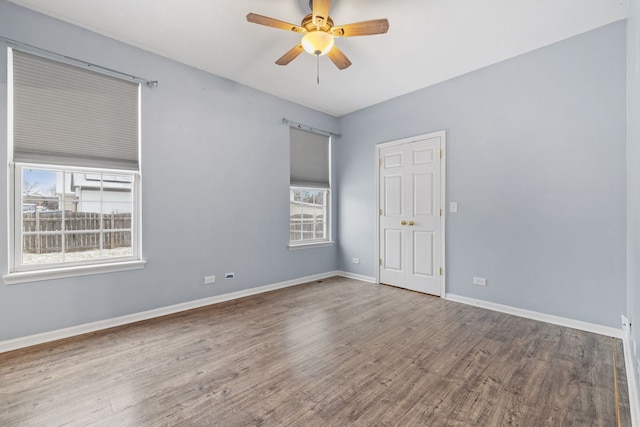 spare room featuring hardwood / wood-style flooring, plenty of natural light, and ceiling fan