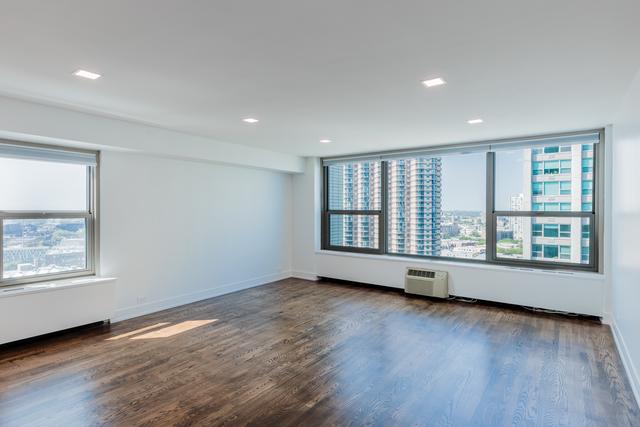 unfurnished room with a wall mounted AC and dark wood-type flooring