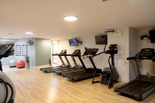 gym featuring light hardwood / wood-style floors