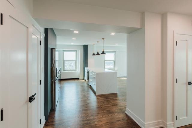 hallway with dark hardwood / wood-style flooring