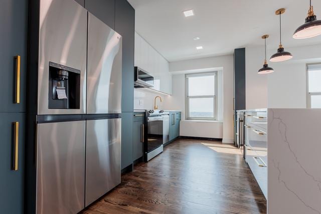 kitchen featuring light stone counters, white range, decorative light fixtures, stainless steel fridge with ice dispenser, and dark hardwood / wood-style floors