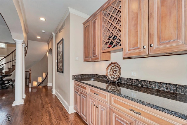 kitchen featuring recessed lighting, dark wood-style flooring, baseboards, dark stone countertops, and decorative columns